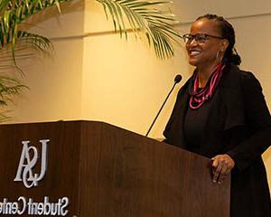 Female speaking at the Student Center on the Stokes Center for Creative Writing.